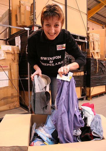 Gerry Dickson loads a box full of clothes and toys